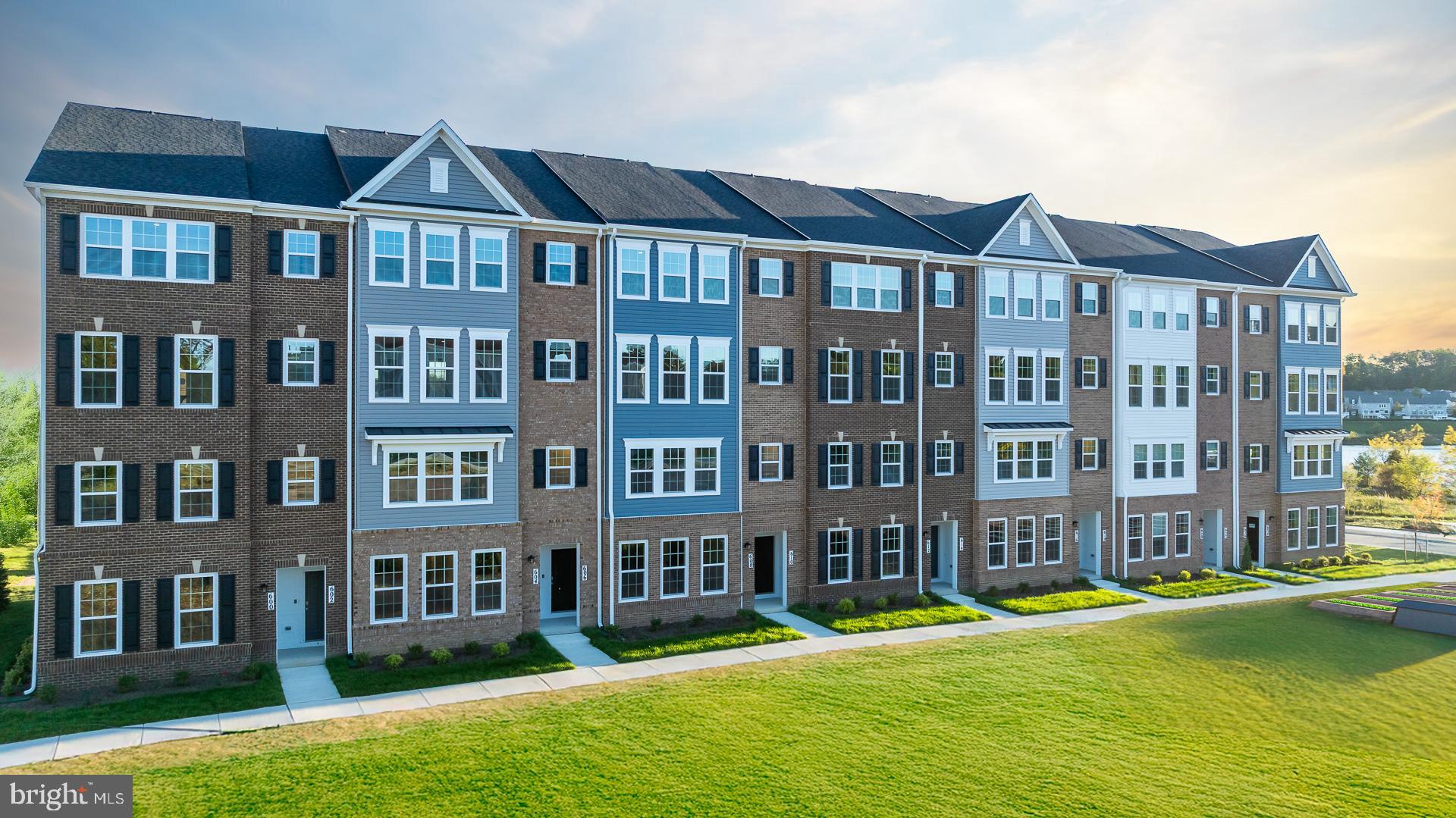 606 Quarry Place Reisterstown, MD 21136 - Photo 14 of 16 a front view of a residential apartment building with a yard