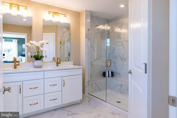 a bathroom with a shower sink and mirror
