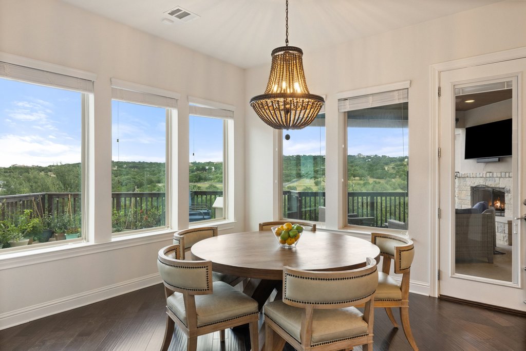 215 Lodestone Lane Austin, TX 78738 - Photo 6 of 40 A spacious dining area features sweeping hillside views and a striking beaded chandelier.