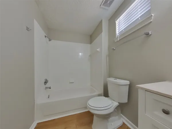 a bathroom with a toilet and a bathtub