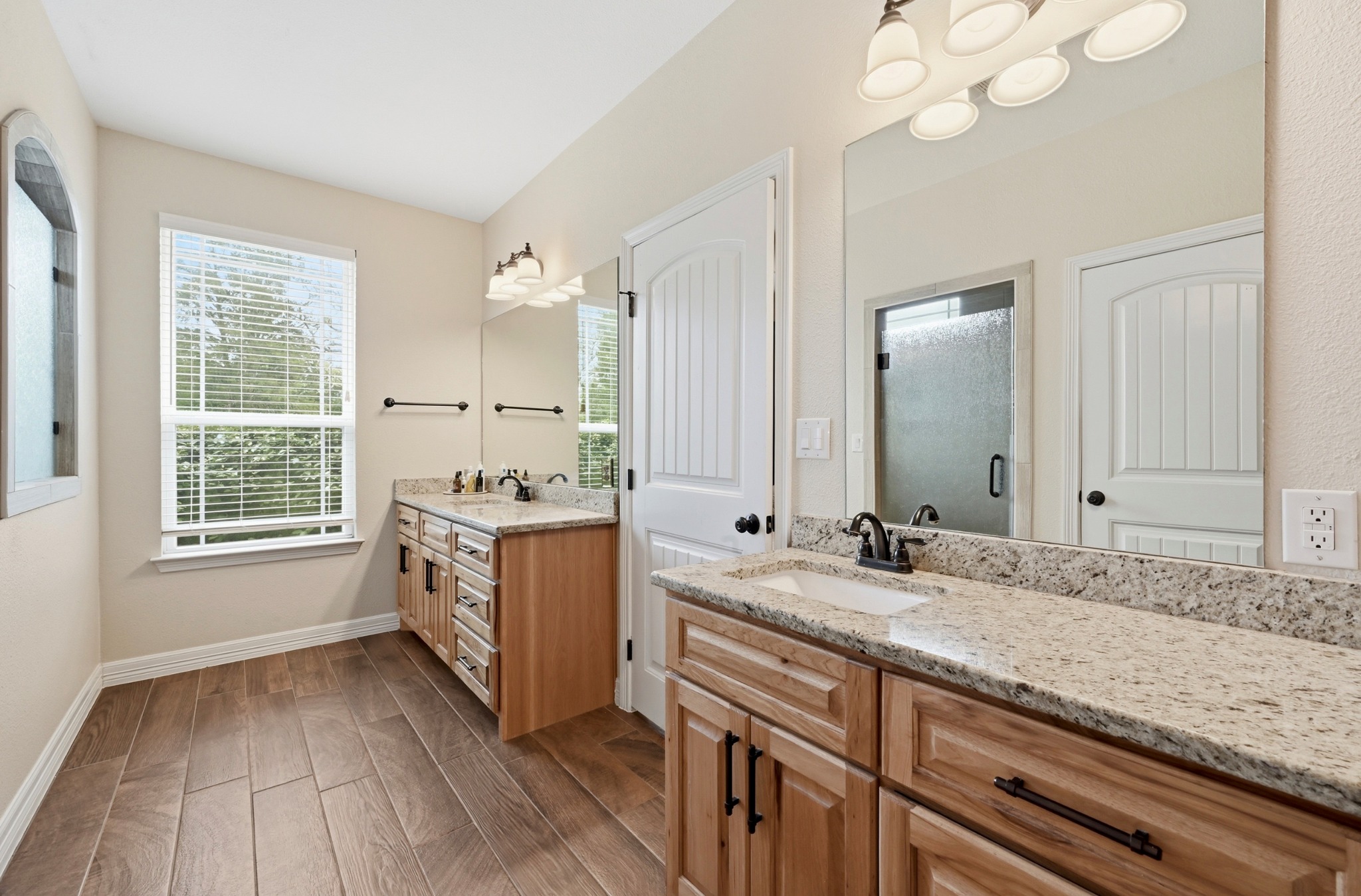 202 Cedar Hills Drive Elgin, TX 78621 - Photo 19 of 37 a bathroom with a sink double vanity granite and a mirror