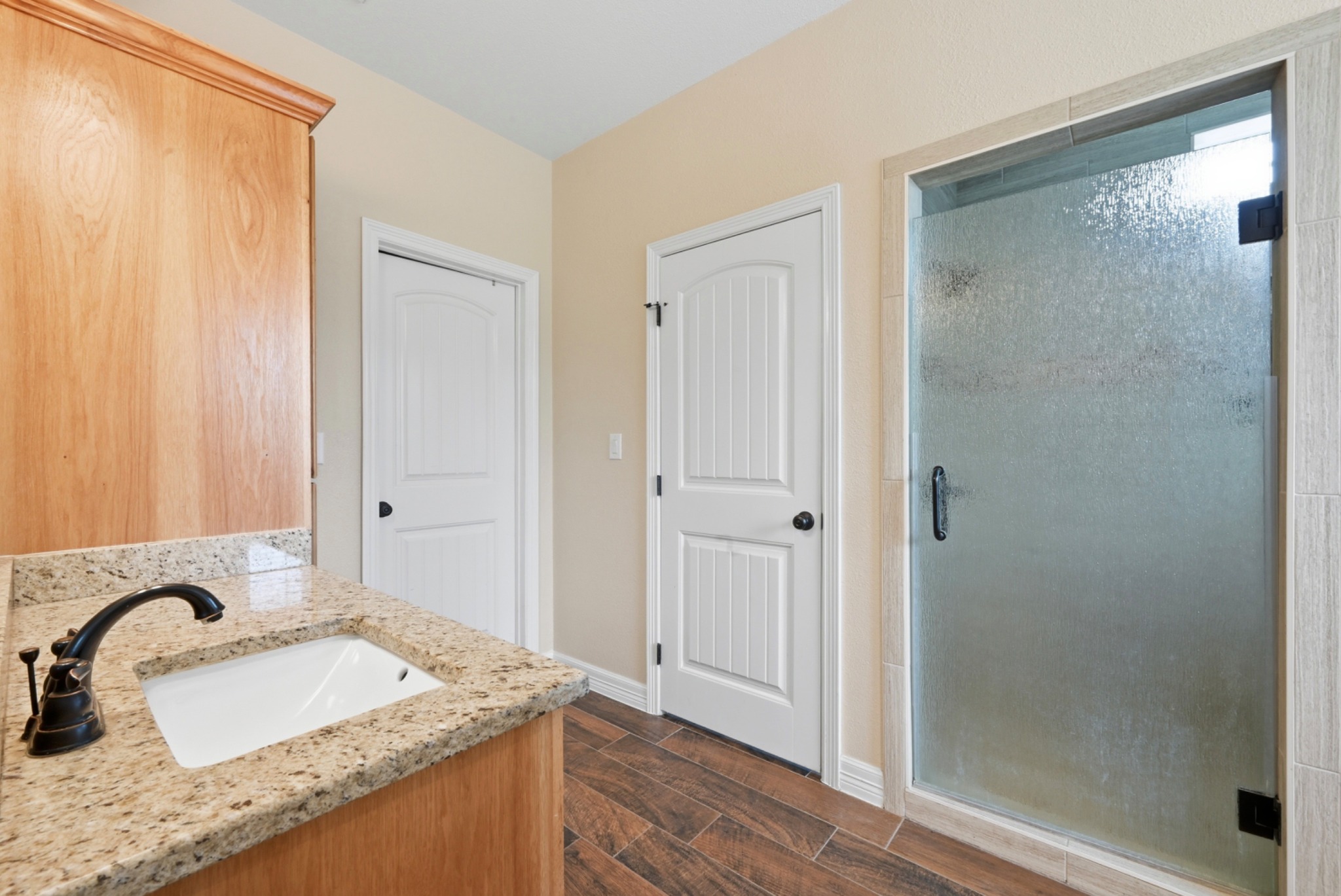 202 Cedar Hills Drive Elgin, TX 78621 - Photo 20 of 37 a bathroom with a granite countertop sink and a mirror