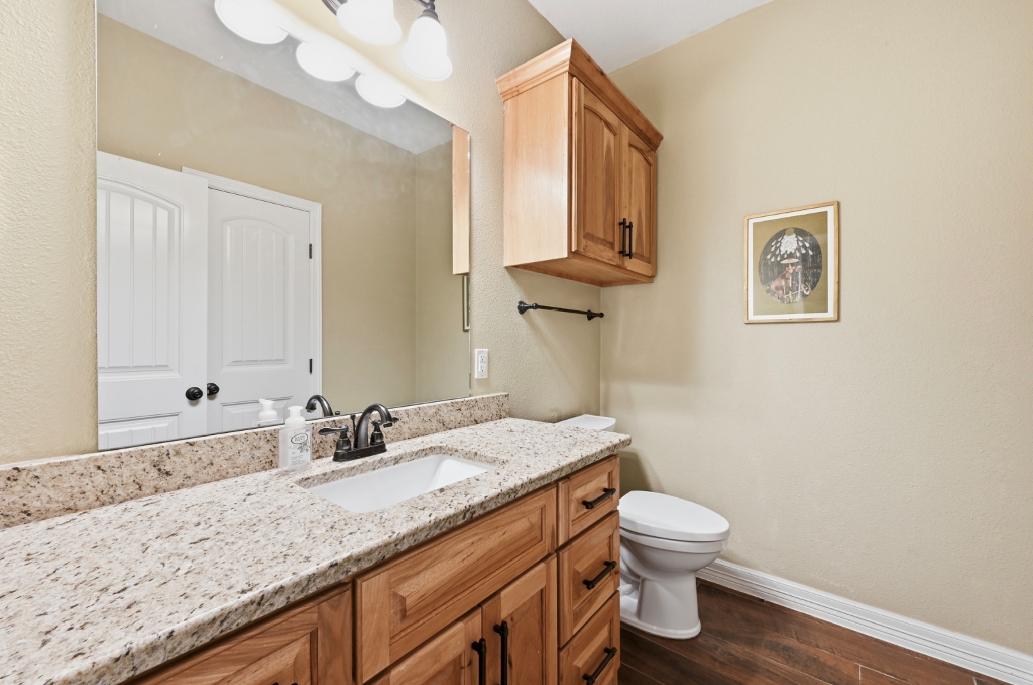 202 Cedar Hills Drive Elgin, TX 78621 - Photo 25 of 37 a bathroom with a granite countertop sink mirror vanity and toilet