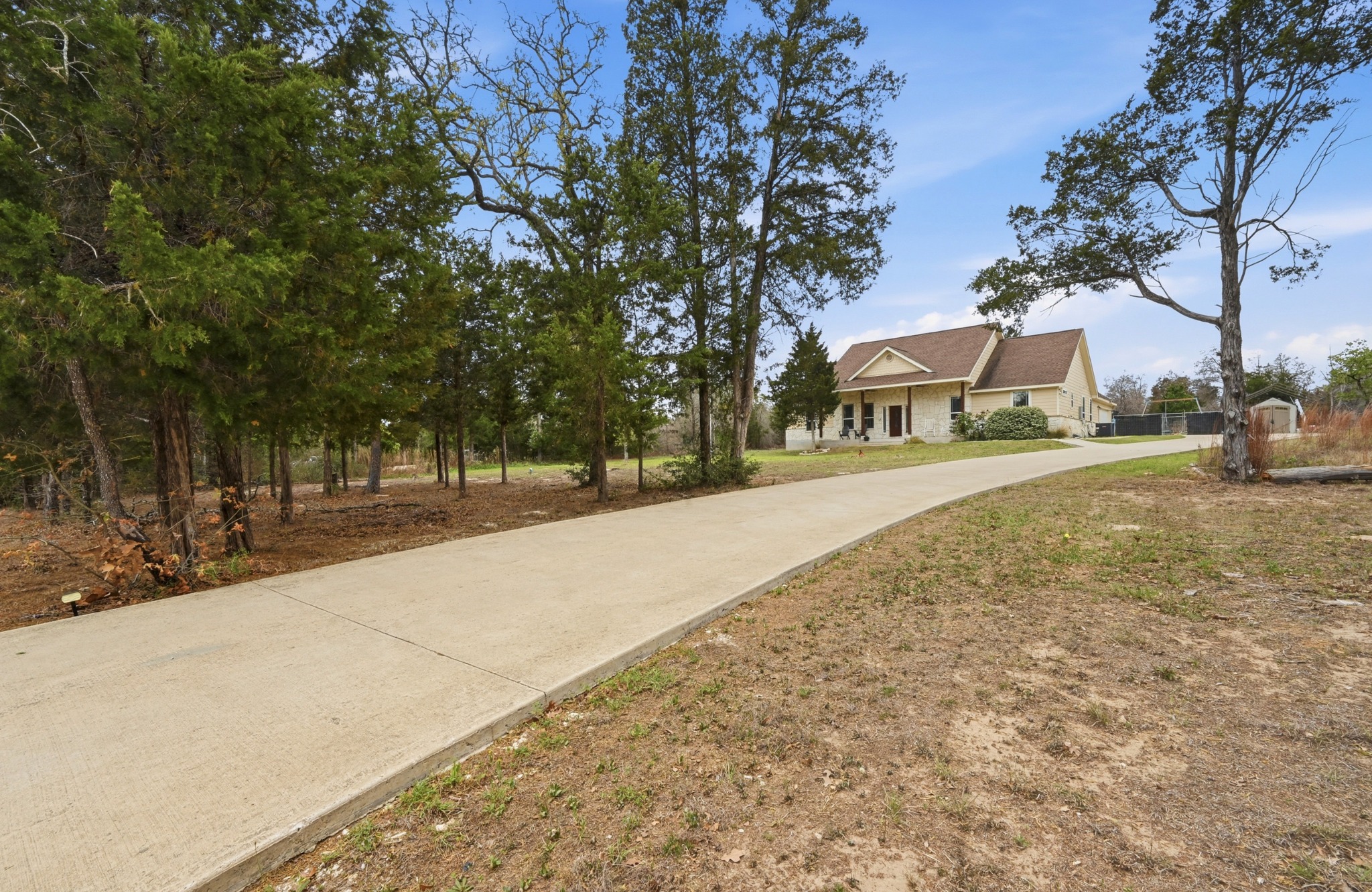 202 Cedar Hills Drive Elgin, TX 78621 - Photo 3 of 37 a street view with large trees