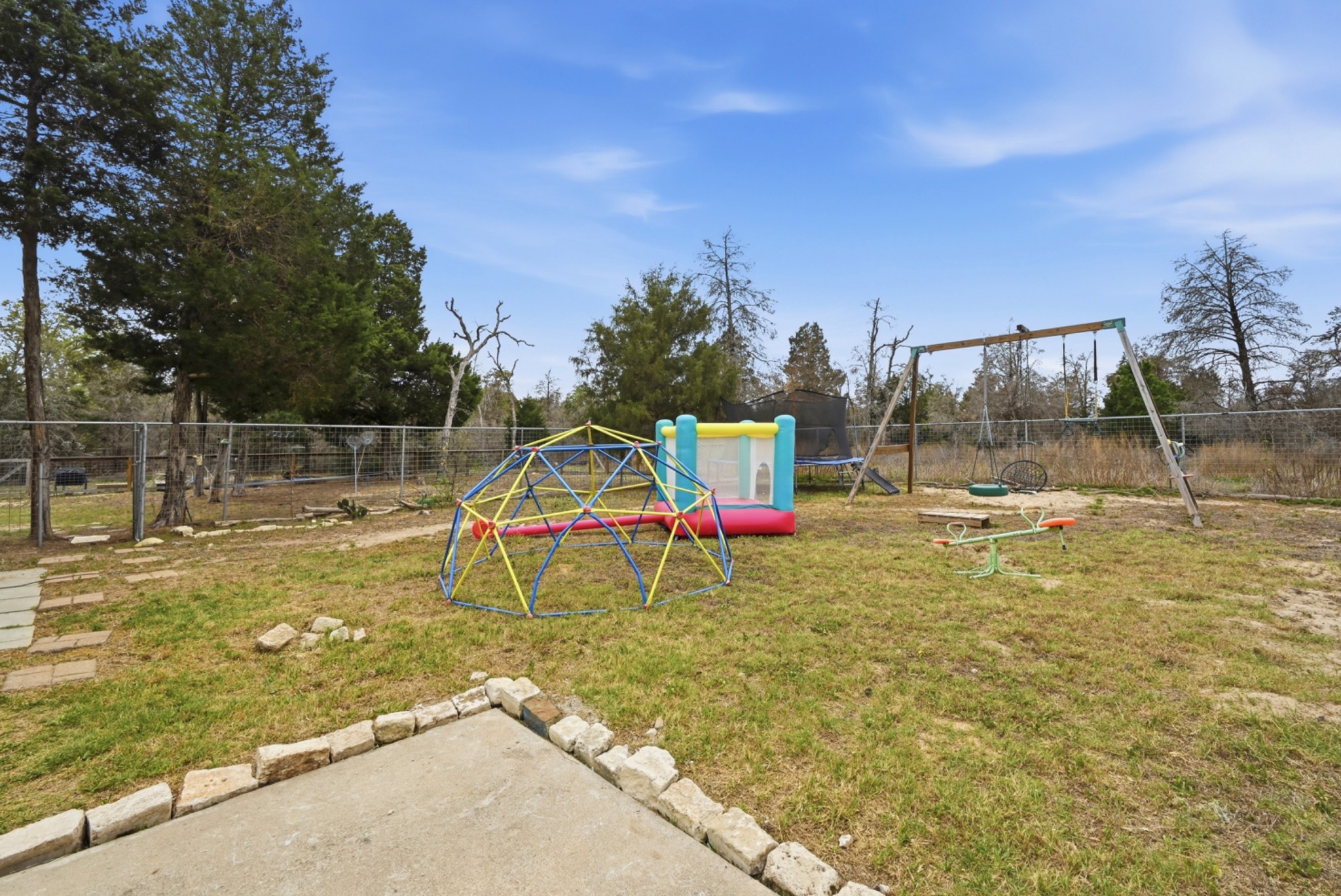202 Cedar Hills Drive Elgin, TX 78621 - Photo 32 of 37 a view of a park with swings and slides