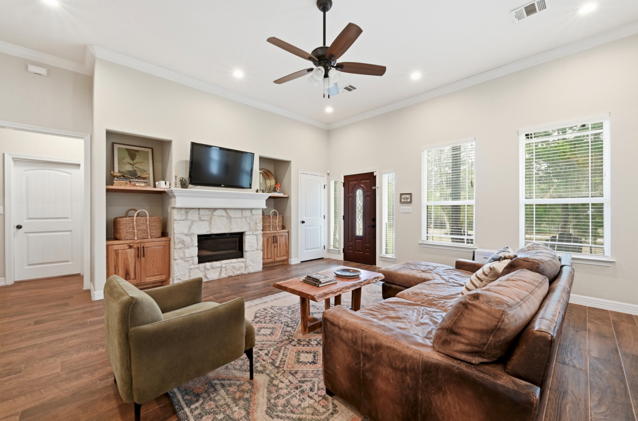 202 Cedar Hills Drive Elgin, TX 78621 - Photo 6 of 37 a living room with furniture a fireplace and a flat screen tv