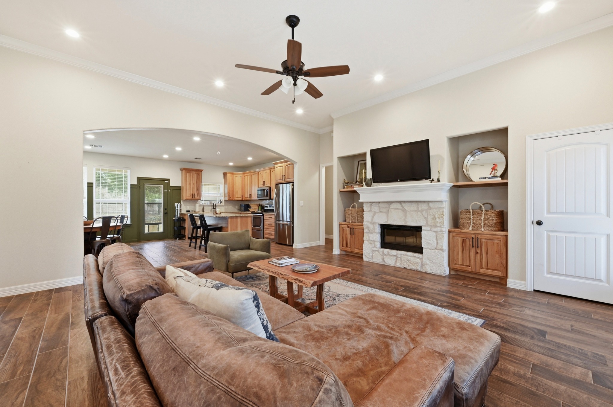 202 Cedar Hills Drive Elgin, TX 78621 - Photo 7 of 37 a living room with furniture a fireplace and a flat screen tv