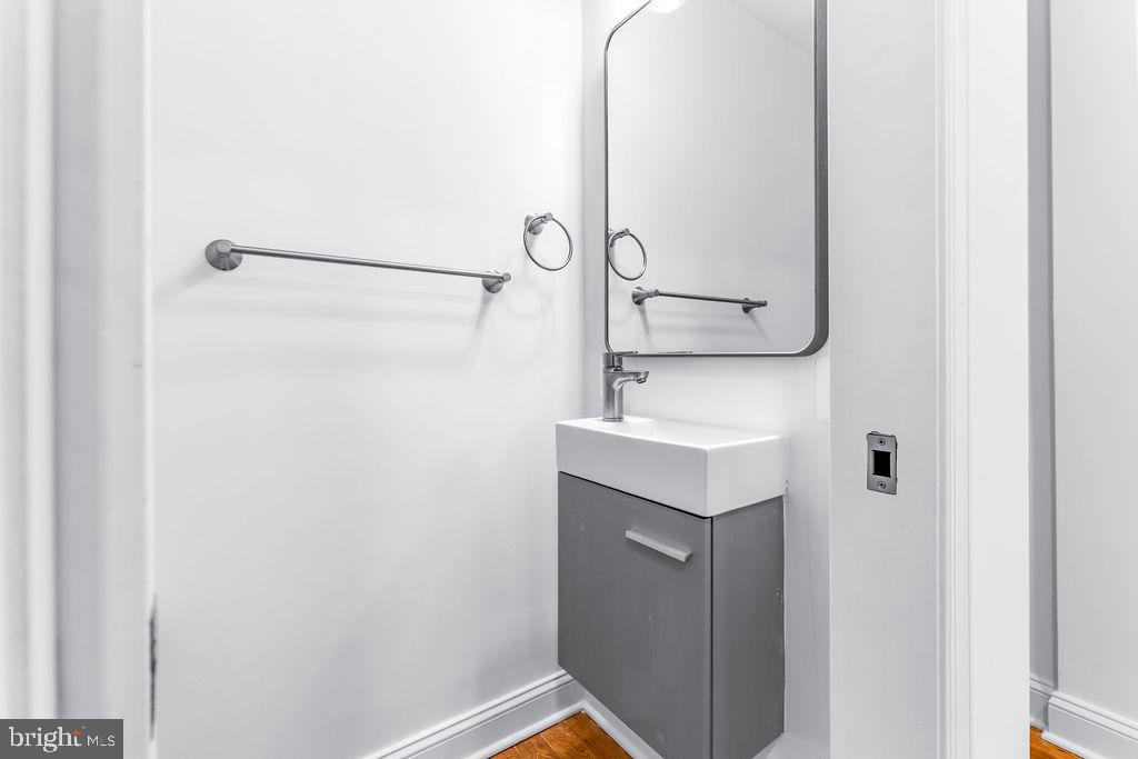 107 South Fulton Avenue Baltimore, MD 21223 - Photo 11 of 36 a bathroom with a sink and mirror