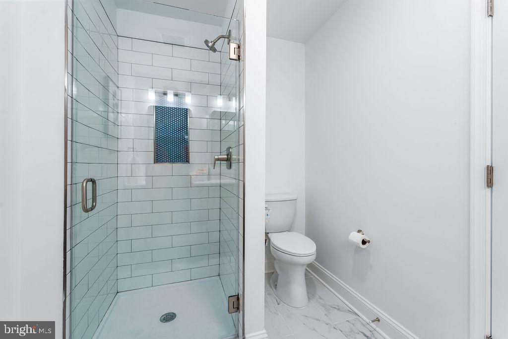 107 South Fulton Avenue Baltimore, MD 21223 - Photo 15 of 36 a bathroom with a shower and a toilet
