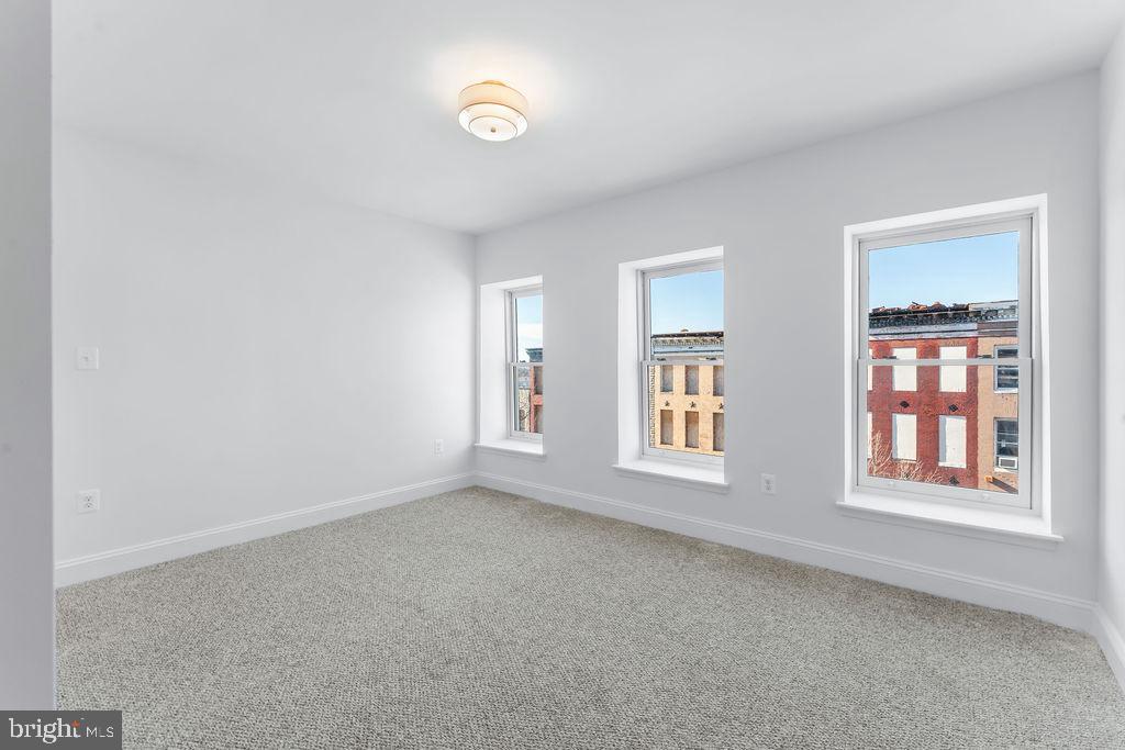 107 South Fulton Avenue Baltimore, MD 21223 - Photo 20 of 36 an empty room with windows