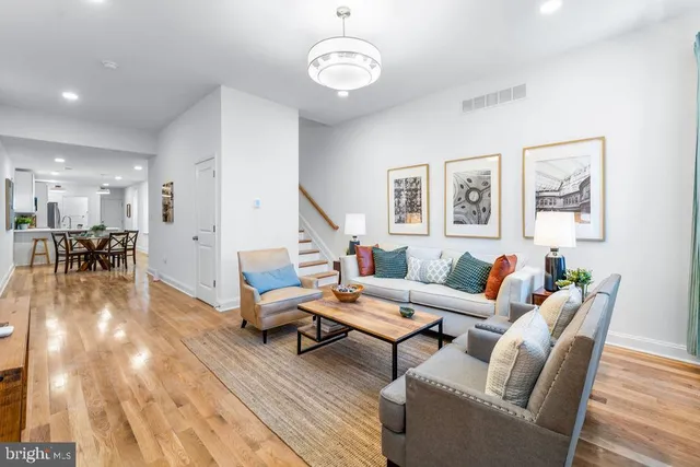 a living room with furniture and wooden floor