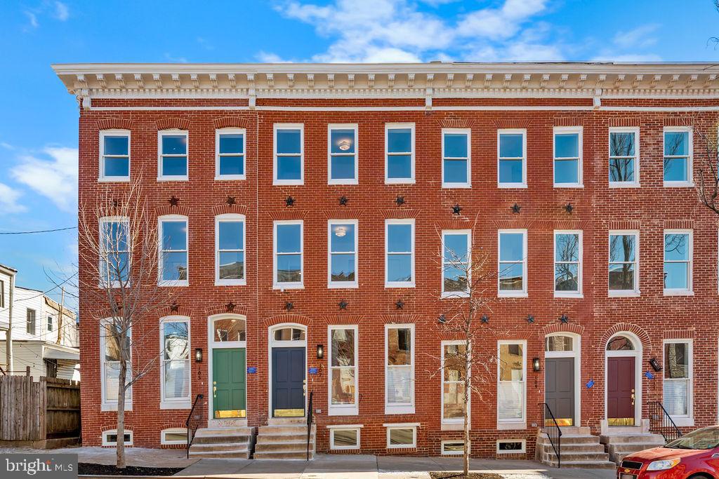 107 South Fulton Avenue Baltimore, MD 21223 - Photo 2 of 36 a front view of a building with glass windows