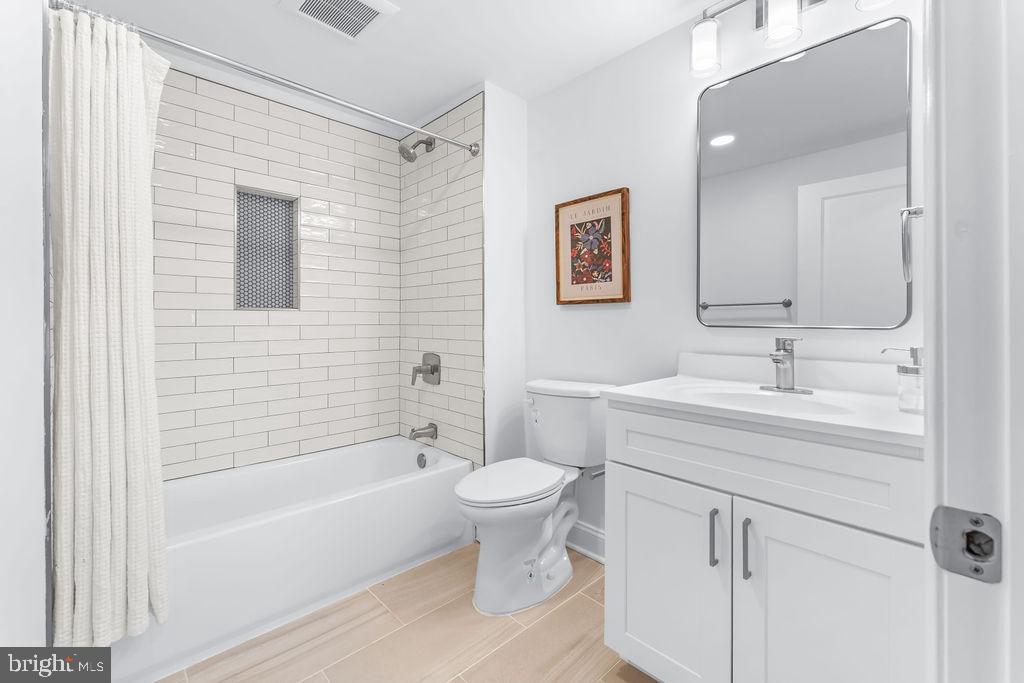 107 South Fulton Avenue Baltimore, MD 21223 - Photo 22 of 36 a bathroom with a sink a toilet and shower