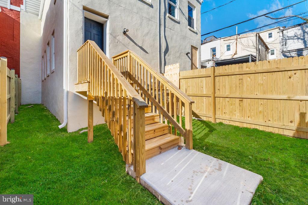 107 South Fulton Avenue Baltimore, MD 21223 - Photo 31 of 36 a view of a house with a yard