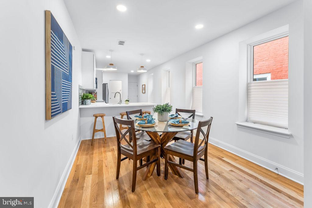 107 South Fulton Avenue Baltimore, MD 21223 - Photo 5 of 36 a view of a dining room with furniture and wooden floor