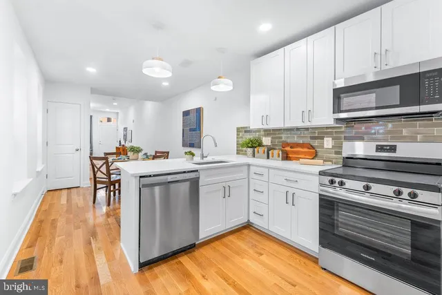 a kitchen with a sink appliances and cabinets