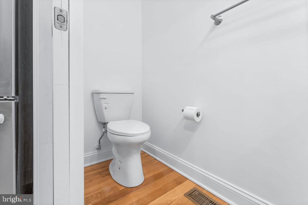 107 South Fulton Avenue Baltimore, MD 21223 - Photo 10 of 36 a white toilet sitting next to a white wall