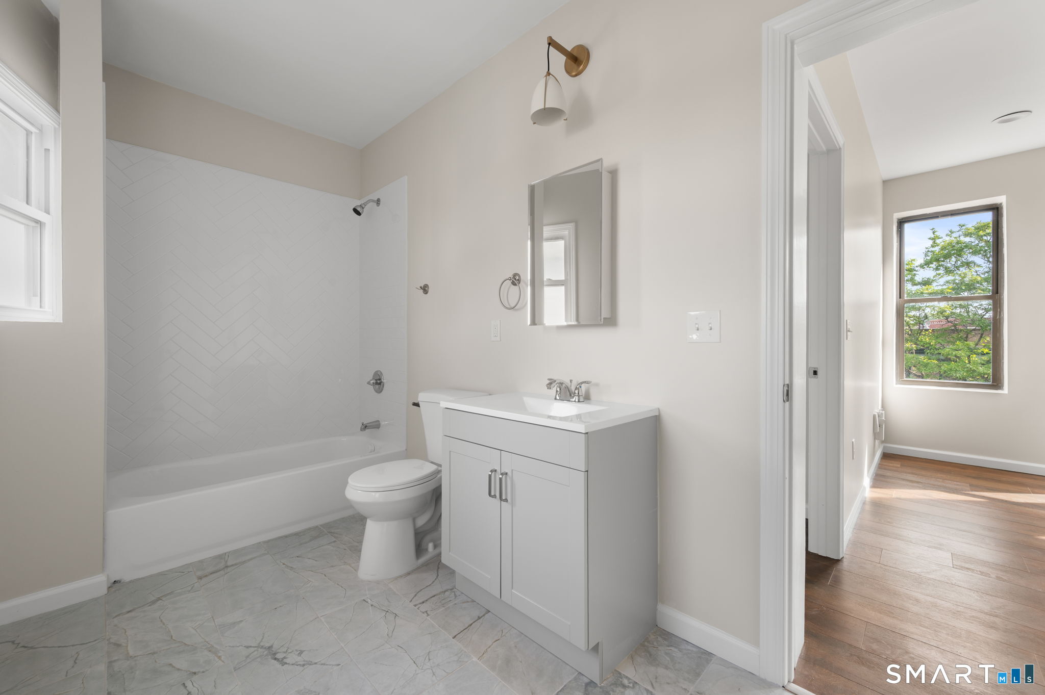 27 Main Street, Unit 6 New Britain, CT 06051 - Photo 4 of 6 a bathroom with a sink a toilet and shower