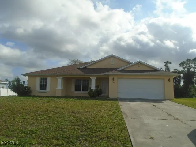 a front view of house with yard and trees