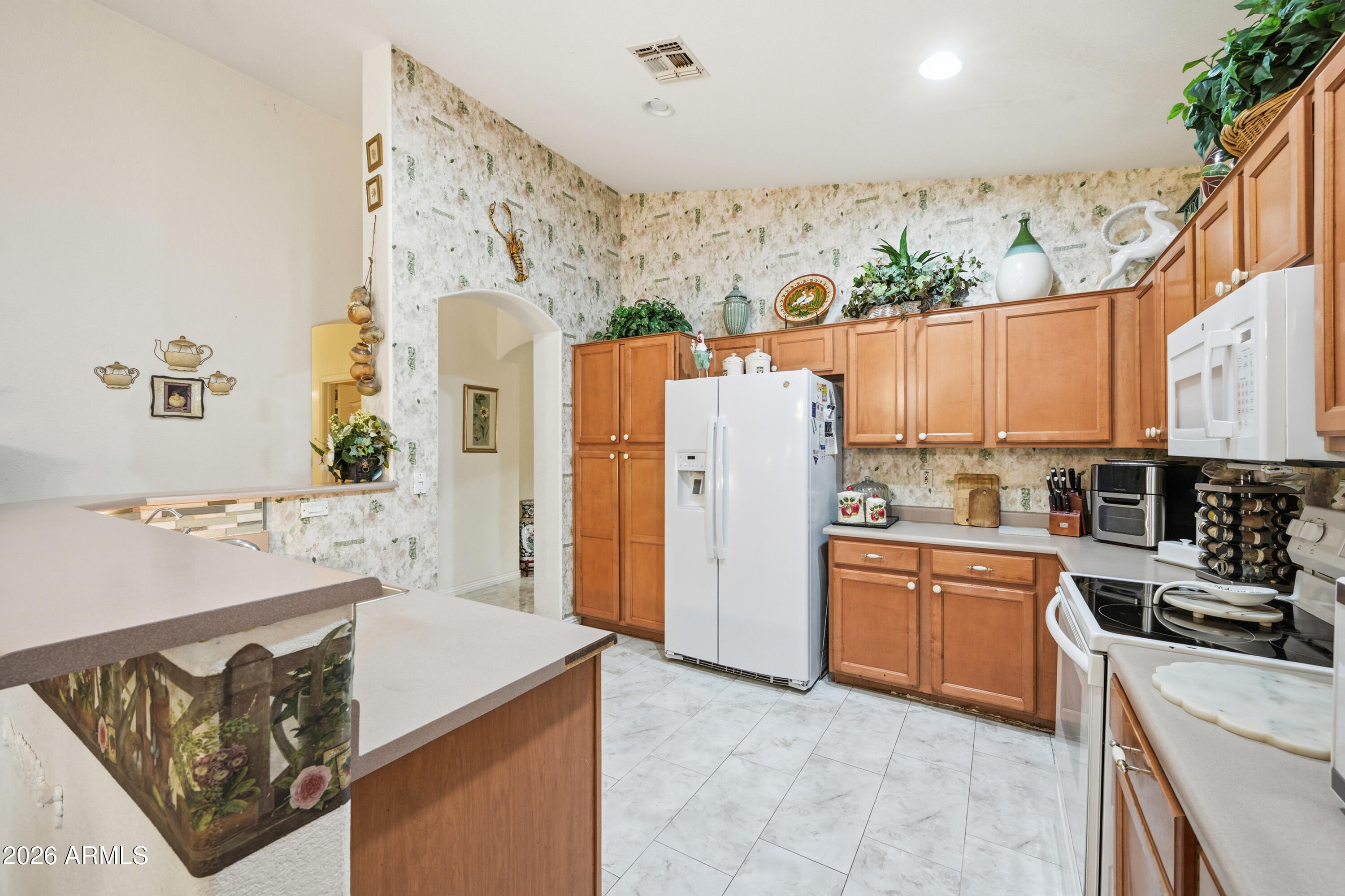 4210 South Splendor Place Gilbert, AZ 85297 - Photo 13 of 38 a kitchen with a refrigerator a stove a sink dishwasher and wooden cabinets with wooden floor