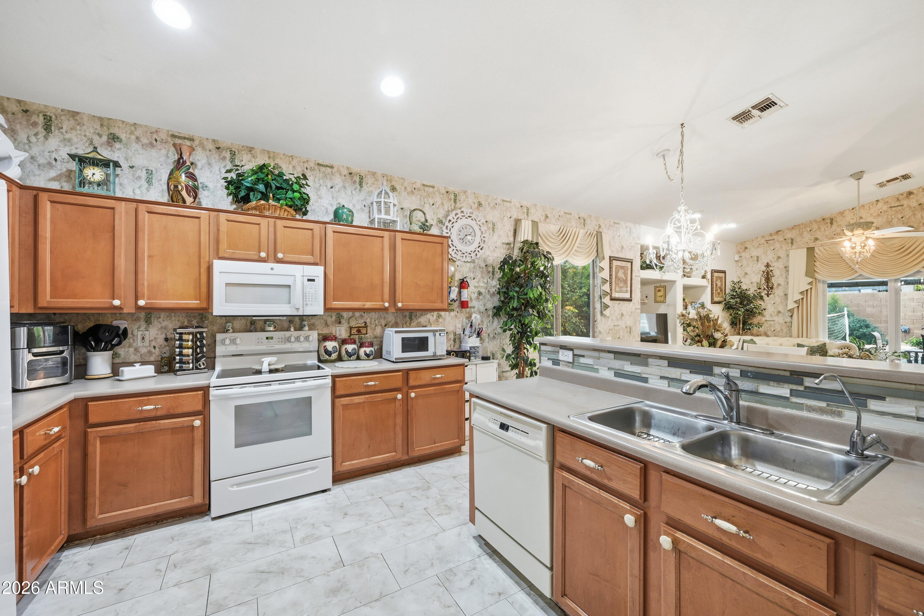 4210 South Splendor Place Gilbert, AZ 85297 - Photo 15 of 38 a kitchen with stainless steel appliances granite countertop a sink and a stove