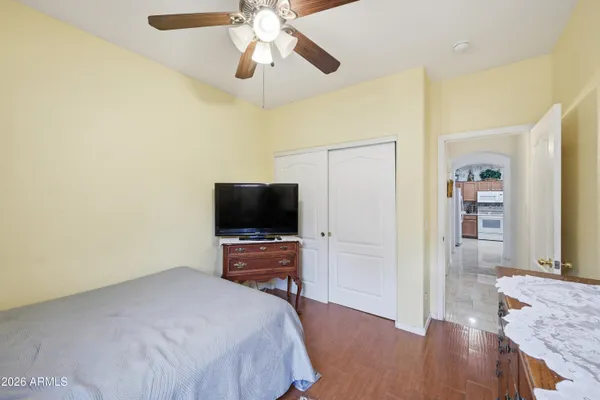 a bedroom with a bed and a flat screen tv