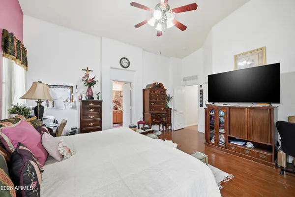 a bedroom with a bed and a flat screen tv
