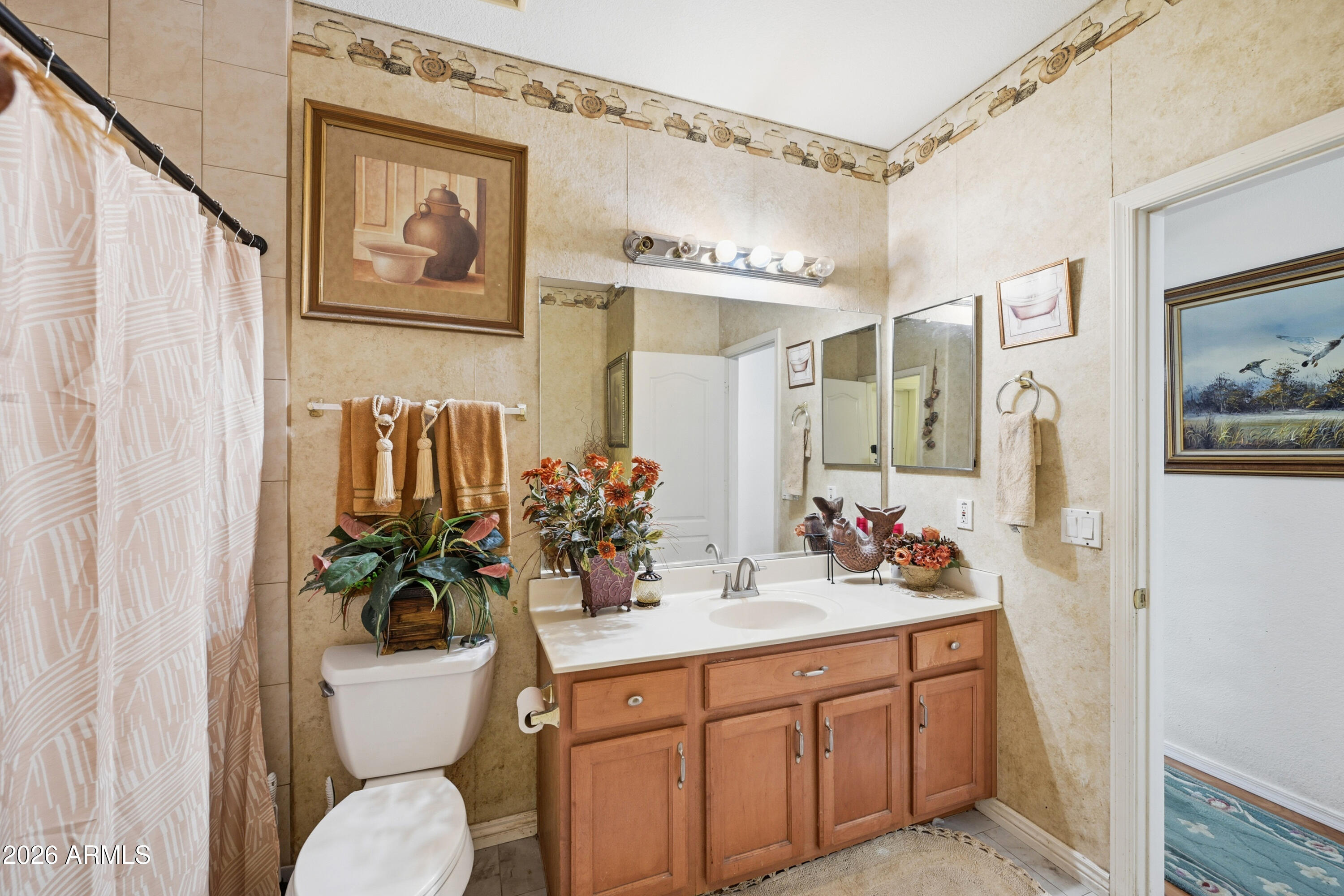4210 South Splendor Place Gilbert, AZ 85297 - Photo 26 of 38 a bathroom with a toilet sink and mirror