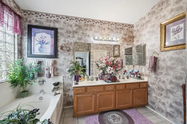 a bathroom with a sink mirror and vanity