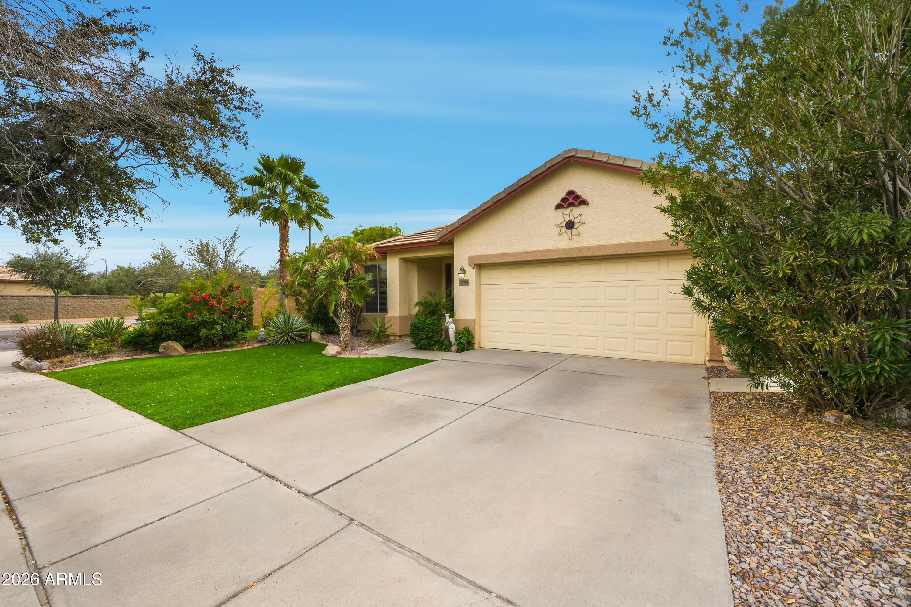 4210 South Splendor Place Gilbert, AZ 85297 - Photo 3 of 38 a front view of a house with a yard and garage