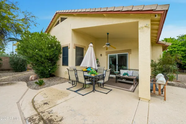 a view of a patio with a table and chairs