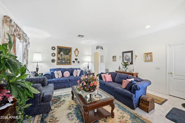 a living room with furniture or couch and a potted plant