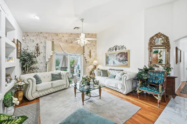 a living room with furniture potted plant and a large window