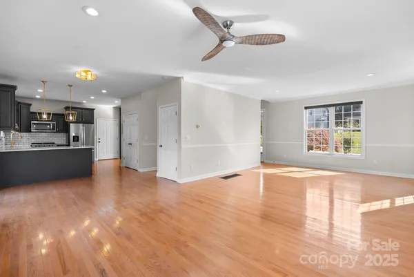 a large kitchen with stainless steel appliances a large counter top