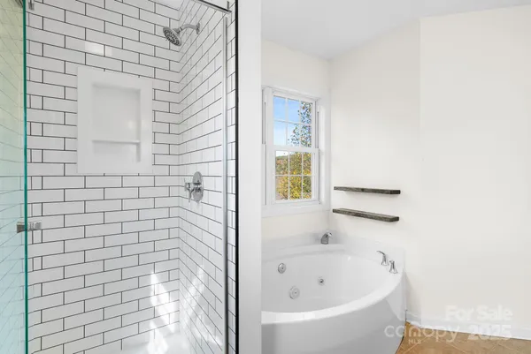 a bathroom with a granite countertop sink a light fixture and a mirror