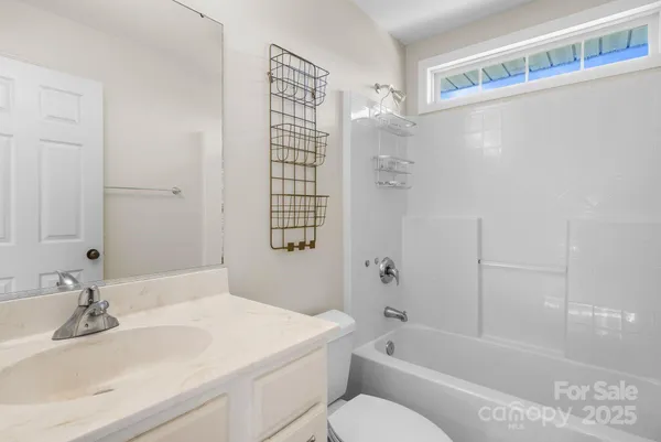 a view of a hallway with wooden floor and stairs
