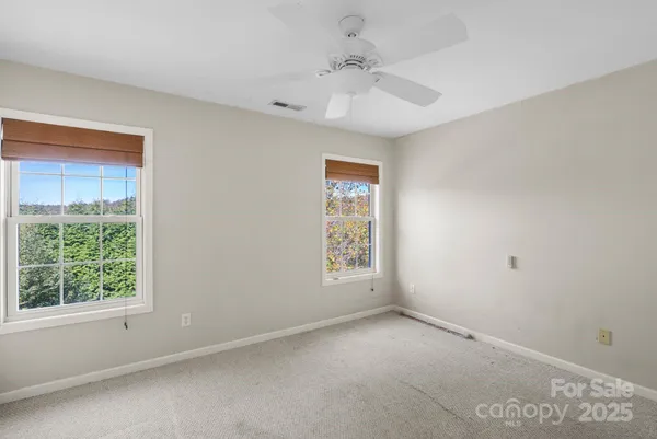 a view of an empty room and a window