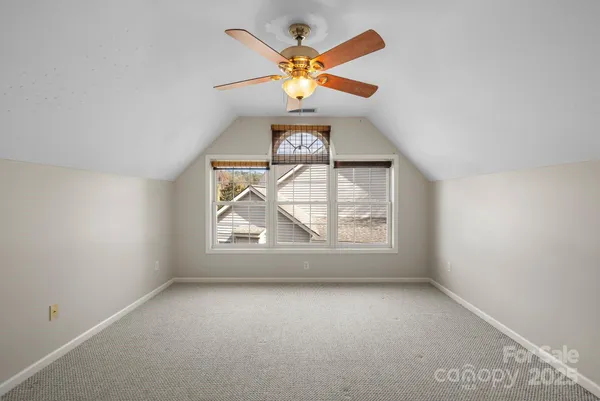 an empty room with closet and windows