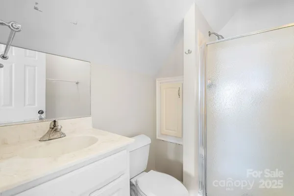 an empty room with wooden floor and natural light