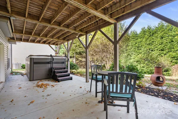 a view of a porch with furniture and a yard
