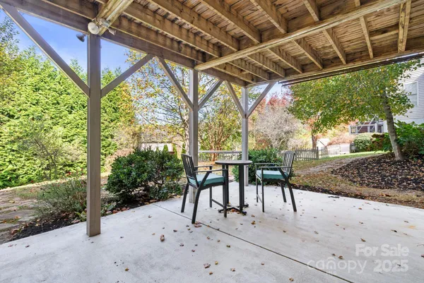 a view of a house with wooden deck and furniture