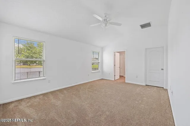 a view of an empty room with a window