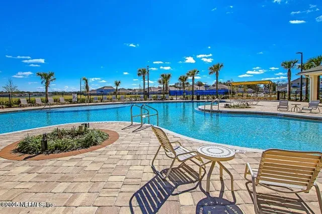 a view of a swimming pool with outdoor seating
