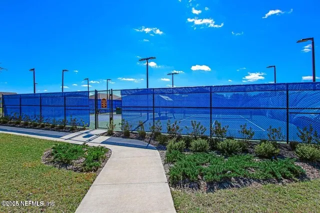 a view of sign board with flower in a garden