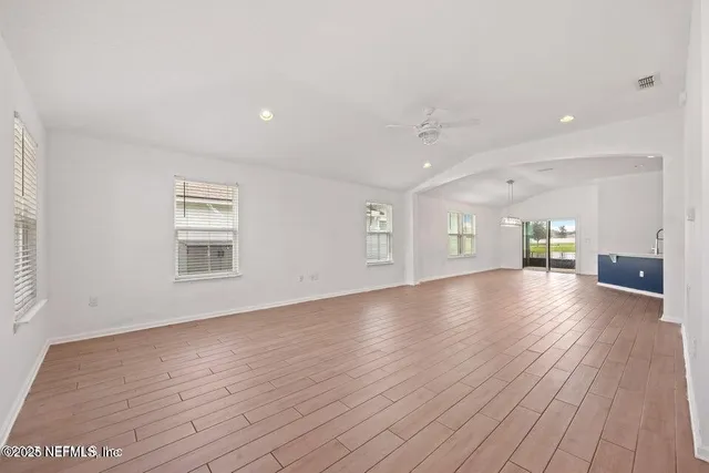 a view of a livingroom with wooden floor and a window