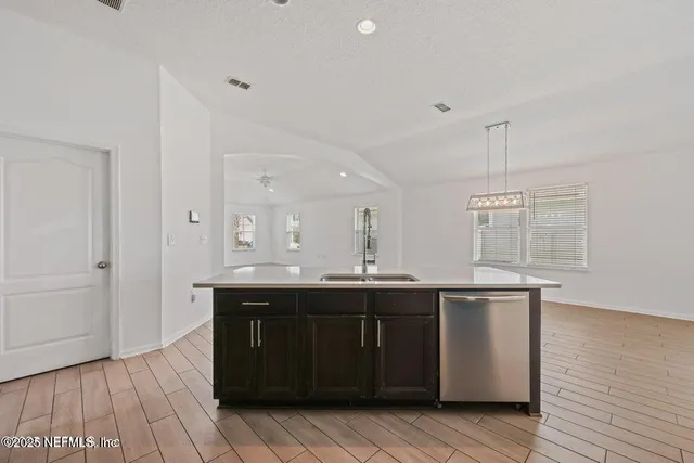 a kitchen with a sink and cabinets