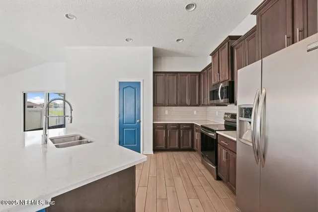 a kitchen with a sink a stove and refrigerator