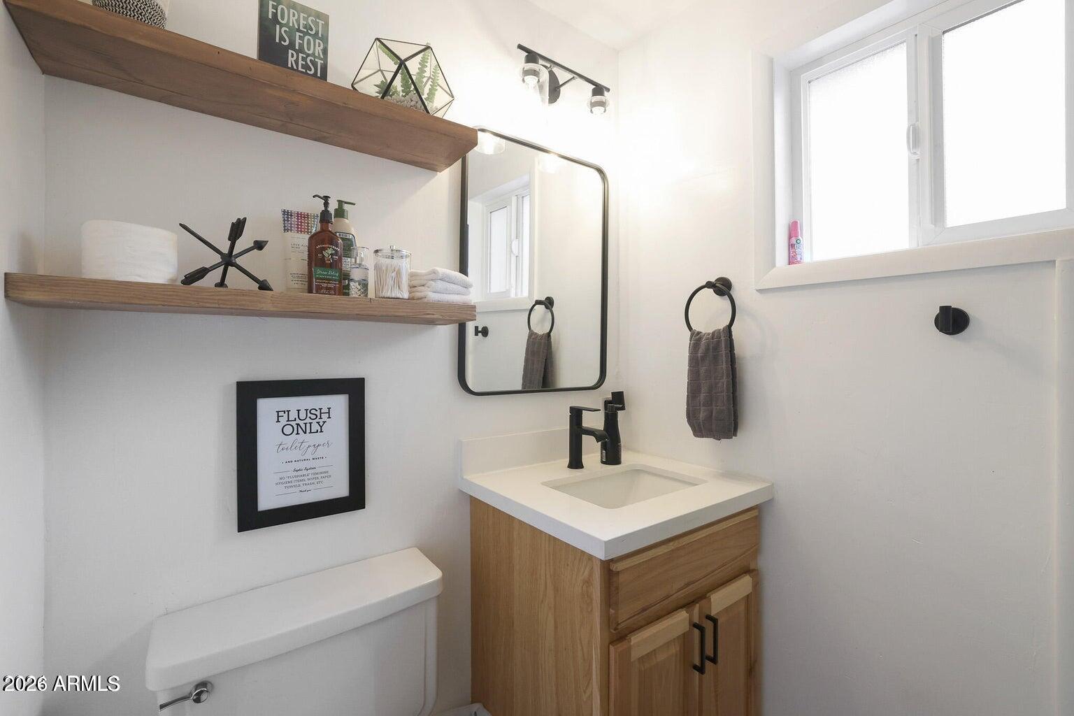 3483 Hillside Road Pine, AZ 85544 - Photo 20 of 54 a bathroom with a toilet sink and mirror