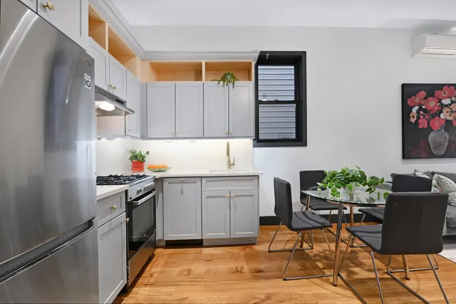 a kitchen with stainless steel appliances kitchen island granite countertop a sink and cabinets