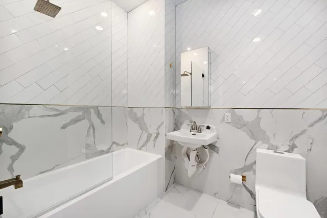 a bathroom with a sink a toilet and bathtub